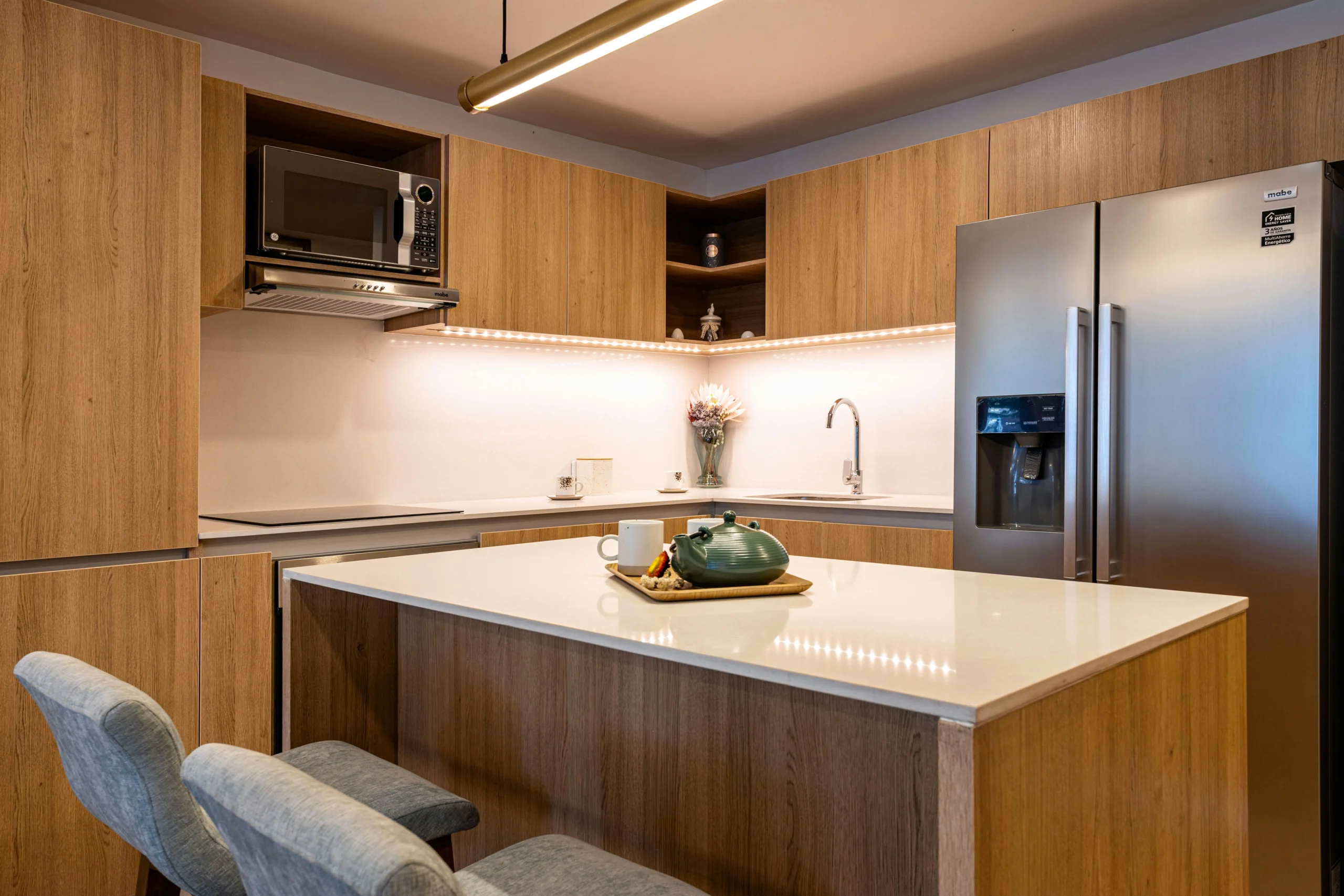 Cocina Minimalista con Isla y Acabados en Madera Clara
