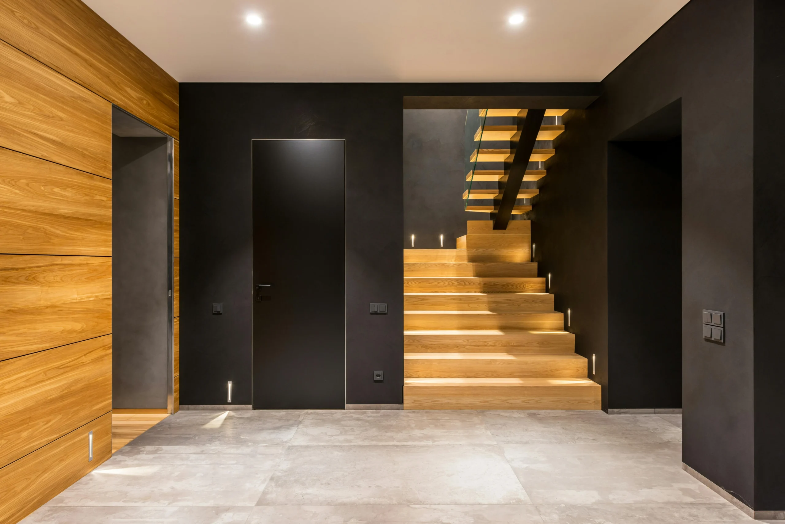 Escalera Escultórica con Madera Clara y Luz Indirecta