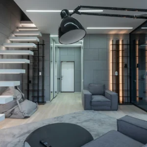 Sala Minimalista con Escalera Flotante y Acabados Grises